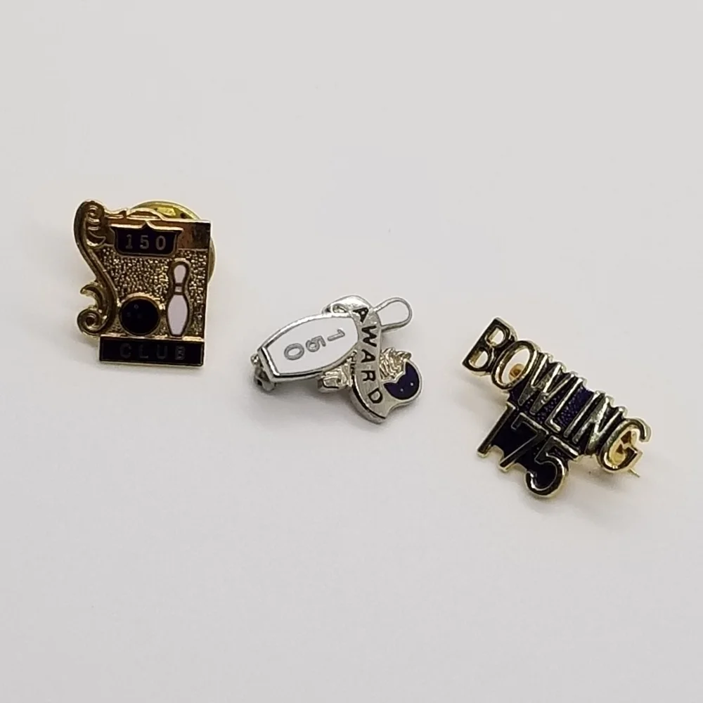 trio of bowling accomplishment pins
